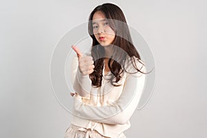 Portrait of attractive cheerful girl demonstrating and pointing finger to the side empty space isolated white background, showing