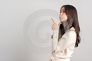 Portrait of attractive cheerful girl demonstrating and pointing finger to the side empty space isolated white background, showing