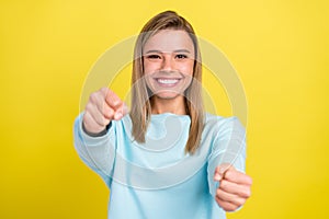 Portrait of attractive cheerful girl driving invisible car way raod free time isolated over bright yellow color