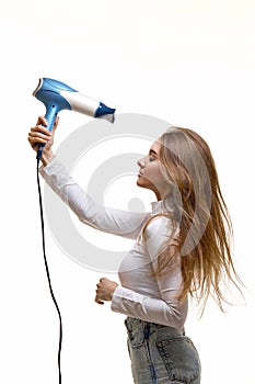 Portrait of attractive cheerful girl drying long hair