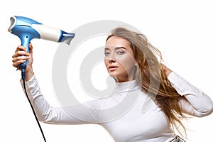 Portrait of attractive cheerful girl drying long hair