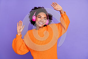 Portrait of attractive cheerful girl fan dancing having fun listening stereo sound hit isolated over bright purple