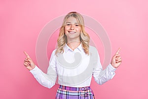 Portrait of attractive cheerful girl showing copy empty blank space ad isolated over pink pastel color background