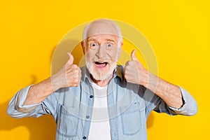 Portrait of attractive cheerful grey-haired man showing two double thumbup ad cool isolated over bright yellow color