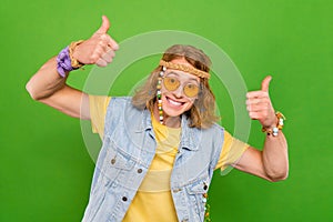 Portrait of attractive cheerful guy showing double thumbup advert ad deal done isolated over bright green color