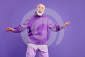 Portrait of attractive cheerful man good mood having fun isolated over bright violet purple color background