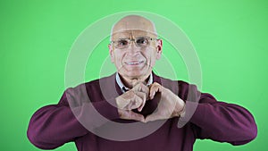 Portrait of attractive cheerful man showing heart shape affection care