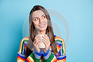 Portrait of attractive cheerful minded brown-haired girl drinking caffeine thinking copy space isolated over bright blue