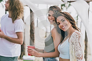 Portrait of attractive cheerful people buddy fellow enjoying weekend day time relax chill out at beach outdoors