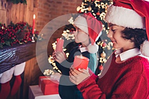 Portrait of attractive cheerful siblings santa helpers preparing festal occasion event newyear tradition celebratory at