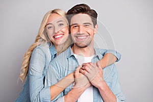 Portrait of attractive cheerful tender couple life partners hugging bonding isolated over gray pastel color background photo