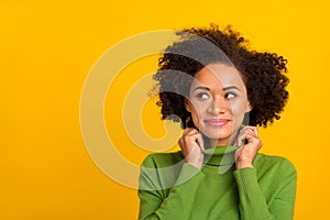 Portrait of attractive cheerful wavy-haired girl fantasizing copy space isolated over bright yellow color background