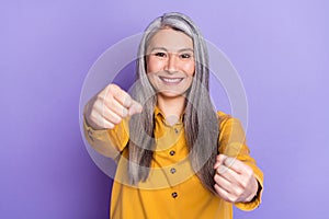 Portrait of attractive cheerful woman driving invisible car isolated on bright violet purple color background