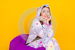 Portrait of attractive cheery dreamy girl wearing animal clothes thinking fantasizing isolated over bright yellow color