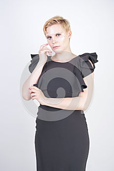 Portrait of attractive chubby young woman in tight black dress