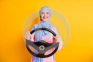 Portrait of attractive content professional cheerful muslimah lady wearing hijab driving invisible car rental isolated