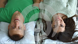 Portrait of attractive couple smiling in bedroom