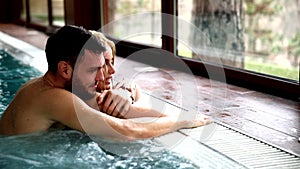 Portrait of attractive couple in swimming pool