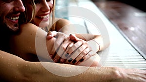 Portrait of attractive couple in swimming pool