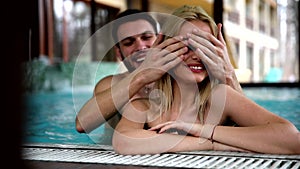 Portrait of attractive couple in swimming pool