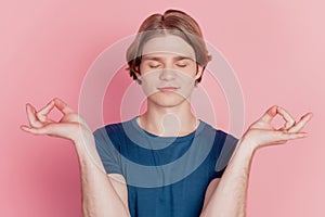Portrait of attractive dreamy calm focused guy meditating dreaming isolated over pink color background