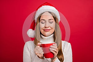 Portrait of attractive dreamy cheery woman drinking eggnog festal day time rest isolated over bright red color