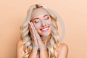 Portrait of attractive dreamy cute cheery wavy-haired girl sleeping enjoying isolated over beige pastel color background