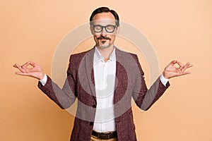 Portrait of attractive dreamy focused serene man top executive director meditating isolated over beige color background