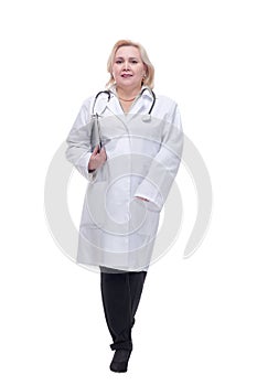 Portrait of attractive female doctor walking with clipboard