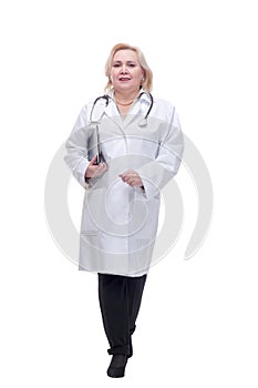 Portrait of attractive female doctor walking with clipboard