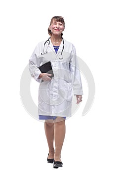 Portrait of attractive female doctor walking and smiling at camera