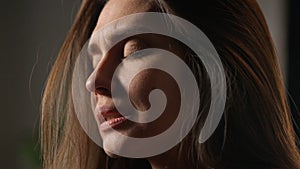 Portrait of attractive female model in negative mood. Close up shot brunette woman face in depressed mood, crying hiding