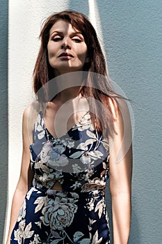 Portrait of an attractive female model posing against a white wall