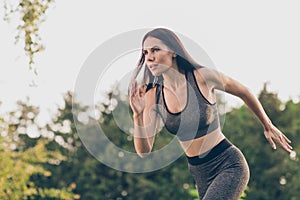 Portrait of attractive focused purposeful girl doing workout running early morning day shaping pilates outdoor