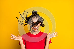 Portrait of attractive funny cheeeful careless girl throwing hair having fun isolated on bright yellow color background