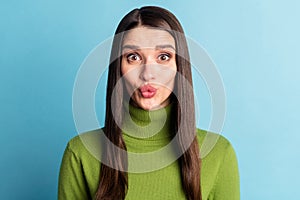 Portrait of attractive funny cheery amorous girl sending air kiss isolated over bright blue color background