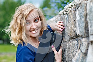 Portrait attractive girl with blond hair in a park