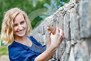 Portrait attractive girl with blond hair in a park
