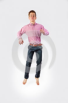 Portrait of attractive jumping smiling boy in puberty