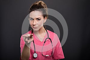 Portrait of attractive lady doctor showing looking watching you