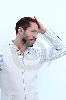 Portrait of attractive man posing while fixing his stylish hair