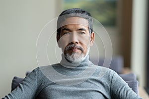 Portrait of attractive mature asian man retired with white styli