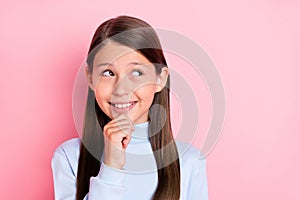 Portrait of attractive minded brainy cheery girl overthinking copy empty space isolated over pink pastel color