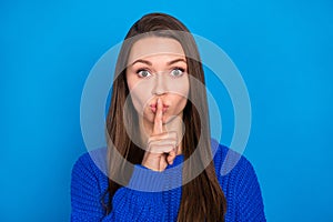 Portrait of attractive mysterious brown-haired girl showing shh sign secret news isolated on bright blue color