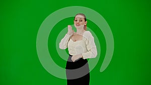 Portrait of attractive office girl on chroma key green screen. Woman in skirt and blouse posing with surprised face