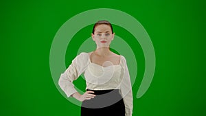 Portrait of attractive office girl on chroma key green screen. Woman in skirt and blouse walking confidently, hands on