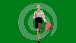 Portrait of attractive office girl on chroma key green screen. Woman in skirt and blouse walking with paper folder and