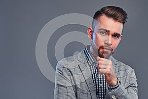 Portrait of attractive pensive man in checkered shirt and  gray blaser