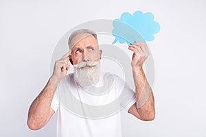 Portrait of attractive pensive man holding in hand cloud copy space deciding  over light grey color background