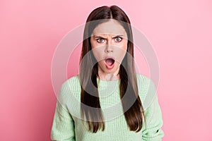 Portrait of attractive person scream fuming open mouth bad mood light green pullover isolated on pink color background